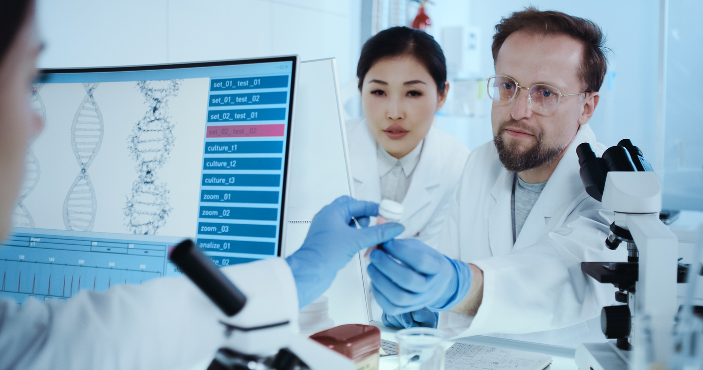 Scientists focused on work. Computer monitors with DNA sequence